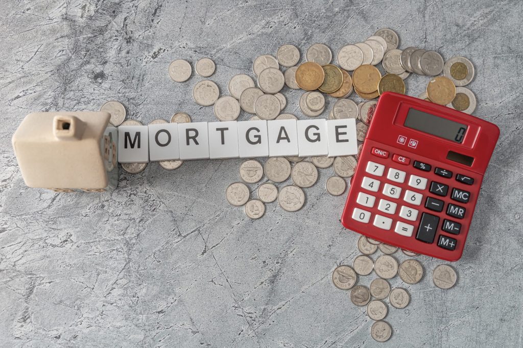 Image of coins, a calculator and mortgage.